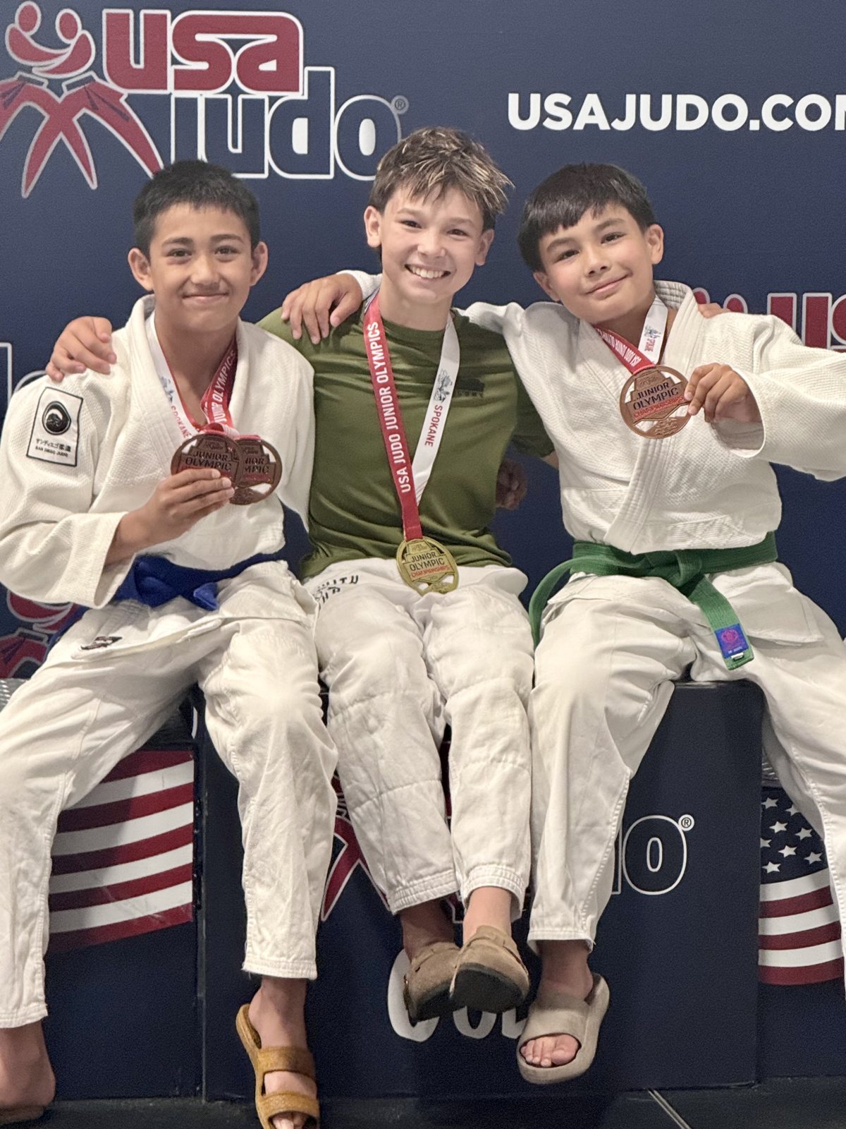 Three San Diego Judo students on the podium at a USA Judo event