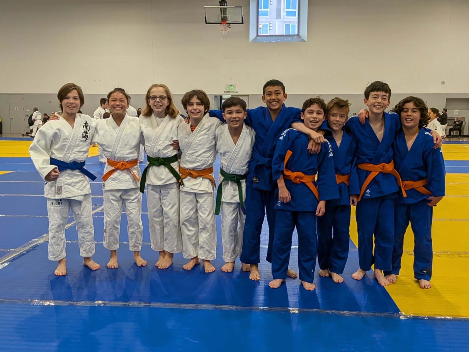 San Diego Judo youth team lined up in blue and white judogi at a tournament